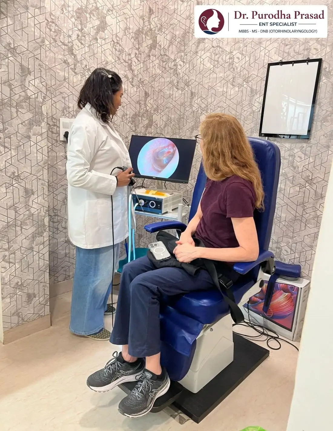 Dr. Purodha Prasad doing ear cleaning of foreigner female patient using endoscope.