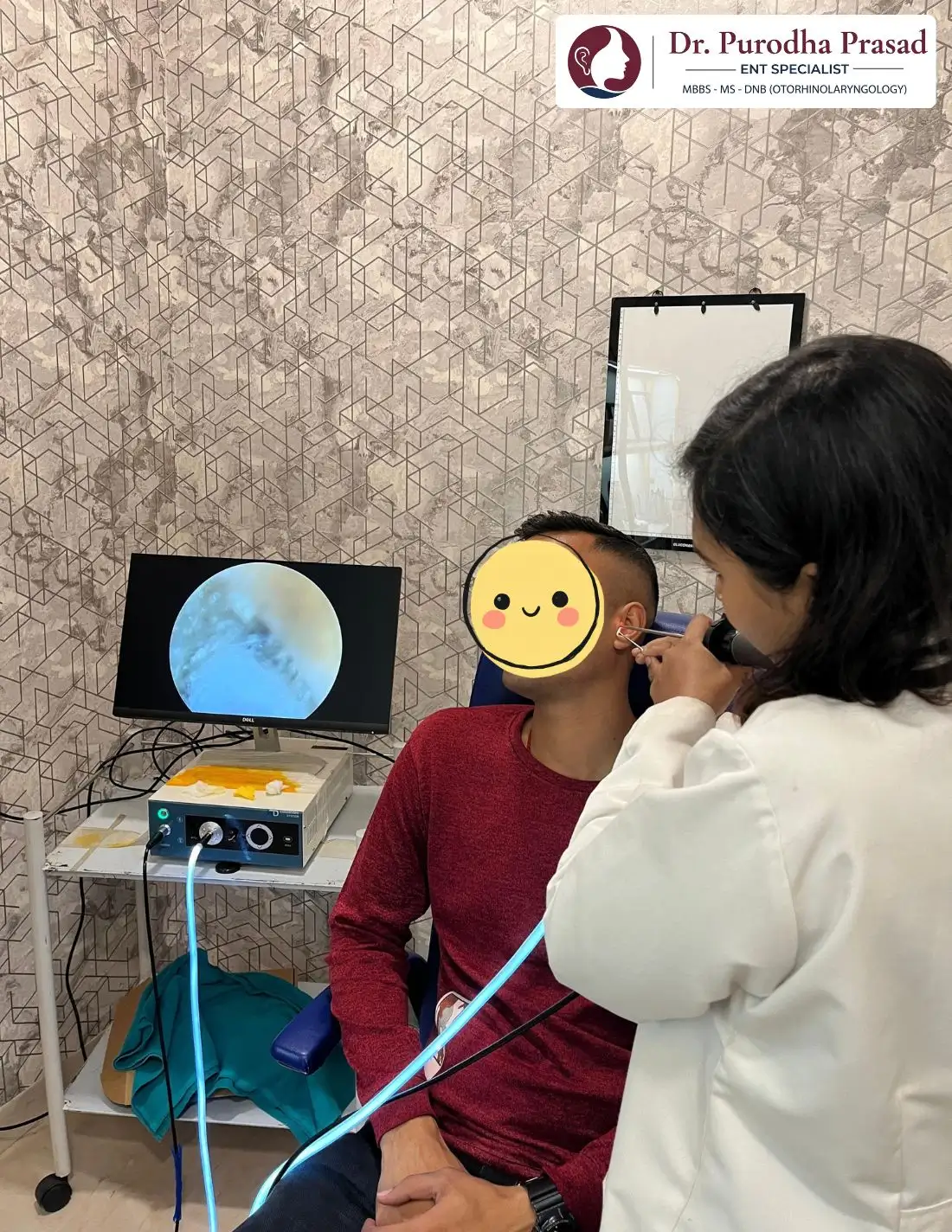 Dr. Purodha Prasad doing ear infection checkup of male patient in Delhi.