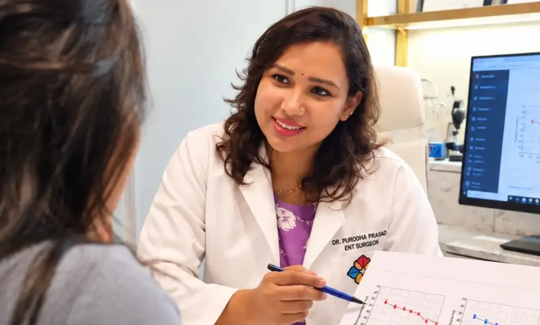 Dr. Purodha Prasad explaining Audiometry report to female patient in Delhi.