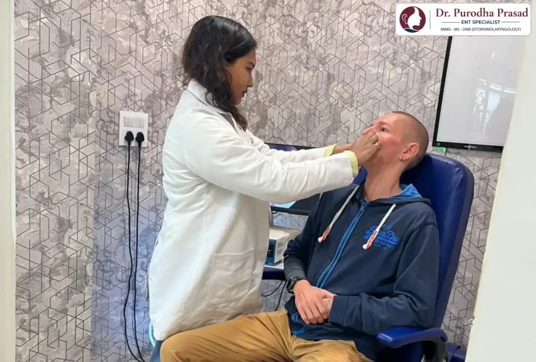 Dr. Purodha Prasad doing nose checkup in South Delhi for male foreigner patient.