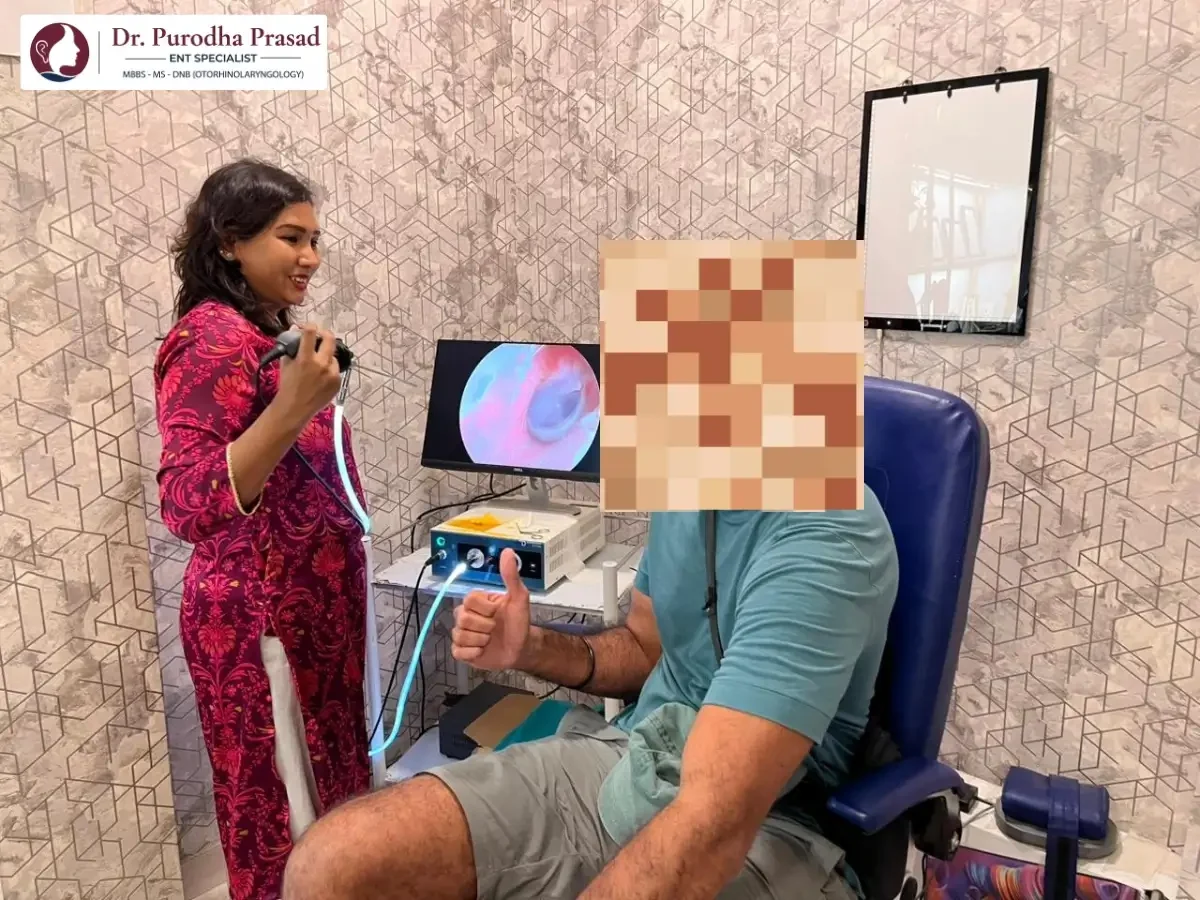 Male patient showing thumbs up to Dr. Purodha Prasad after his ear cleaned.
