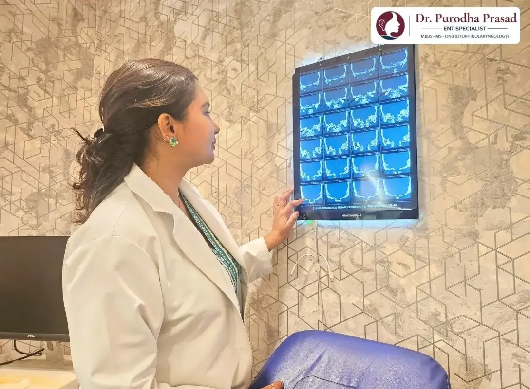 Dr. Purodha Prasad checking MRI scans before Hearing loss surgery in Delhi.