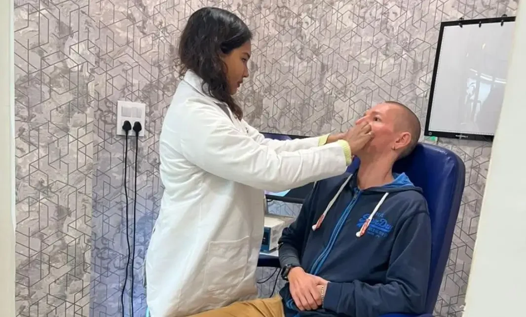 Sinus Specialist Dr. Purodha Prasad checking patient nose.